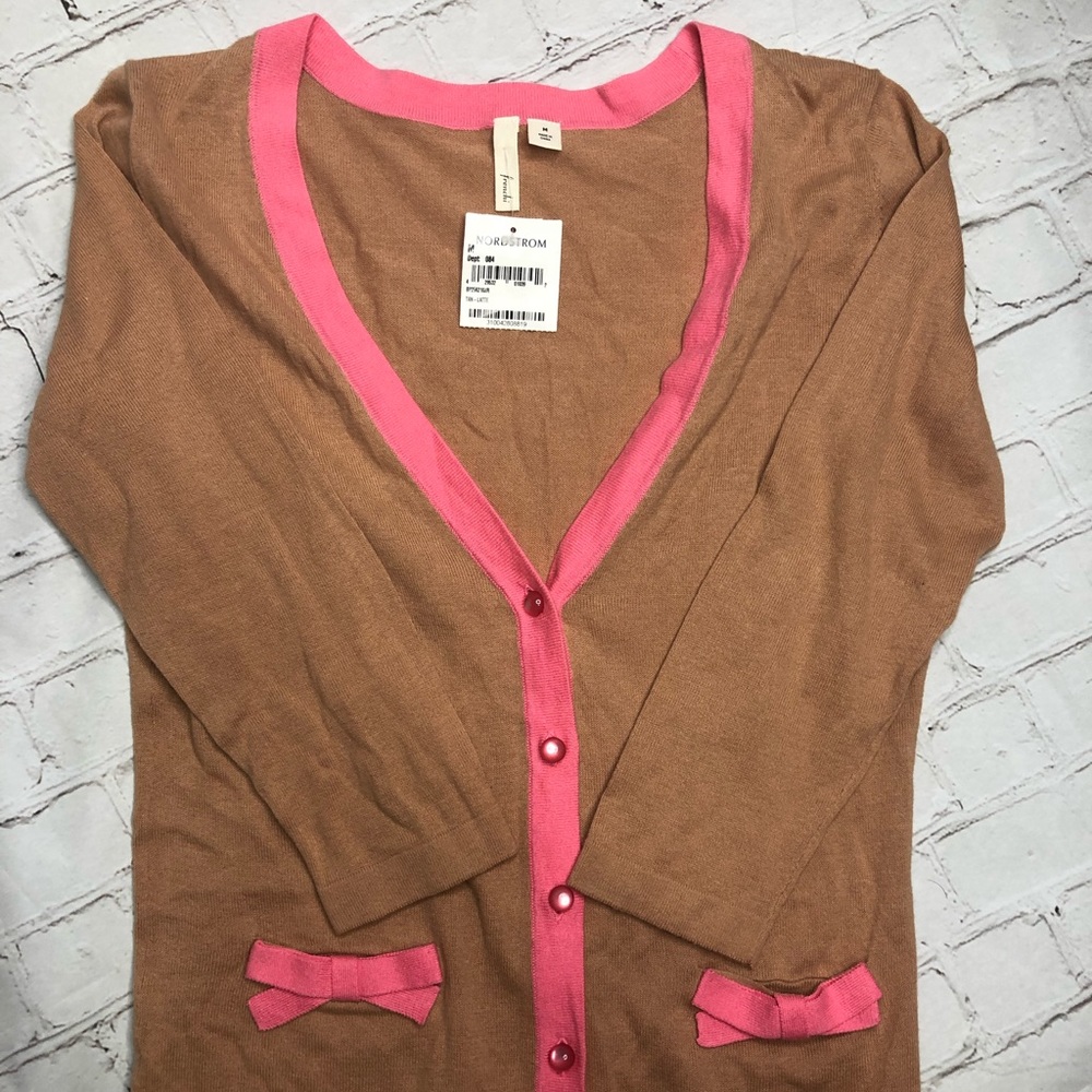 Brown sweater with pink details.